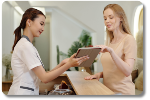 medspa front desk lady helping a woman get scheduled for treatment